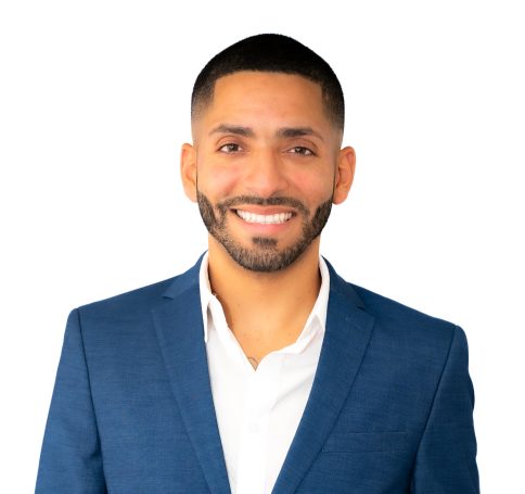 Professional headshot of a man in a blue suit with short hair and neat beard at studio in Miami.