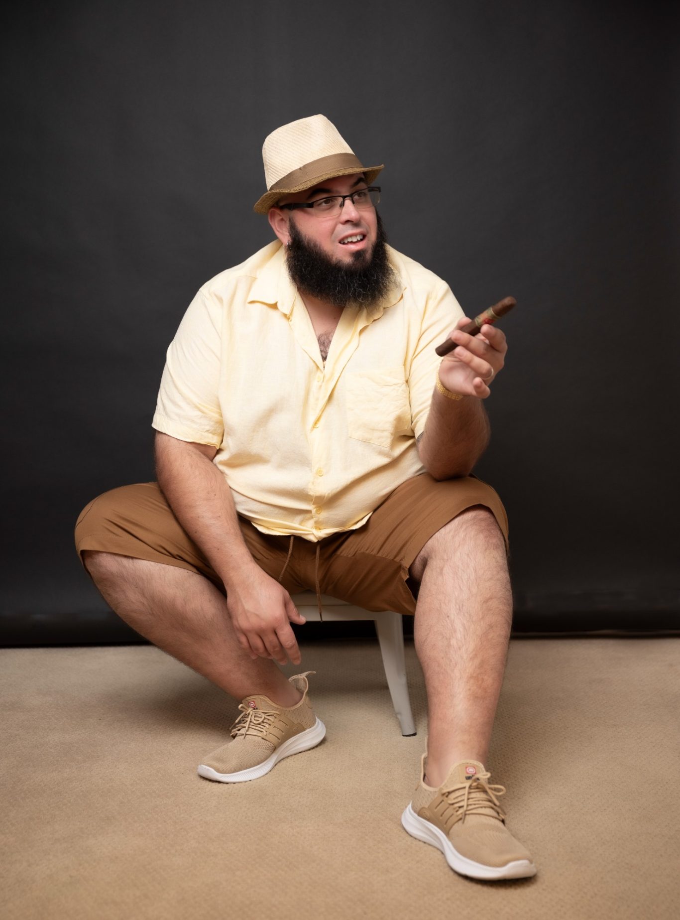 Man sitting and holding cigar