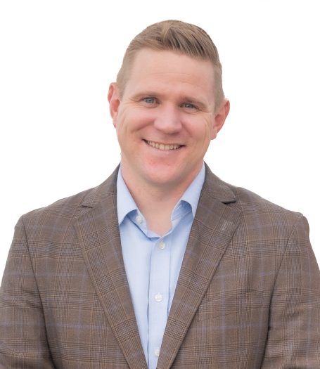 A professional executive man in a blazer and blue shirt against a white background at Miami photo studio Headshot Studio Portraits